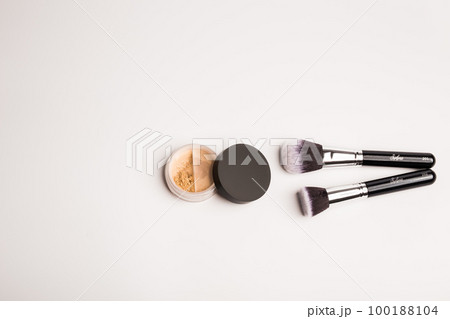 Mineral makeup powder twist seal sifter and brush isolated on white background with copy space. Light beige foundation powder. Skin tone face cosmetic product sample Mineral makeup powder twist seal sifter and brush isolated on white background with copy space. Light beige foundation powder. Skin tone face cosmetic product sample 100188104