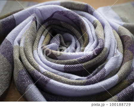 Twisted into a ring violet and olive scarf. Hand woven cashmere shawl. Concept of fashion, weaving and artisanship 100188729