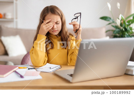 Portrait of kid girl tired from learning and homework 100189992