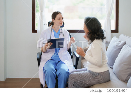 Portrait of a female doctor holding a patient clipboard to discuss and analyze the patient's condition before treating 100191404