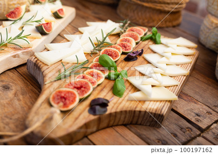 Sliced goat cheese with rosemary, basil and figs for tasting 100197162