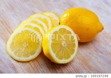 Lemon slices on wooden background 100197298