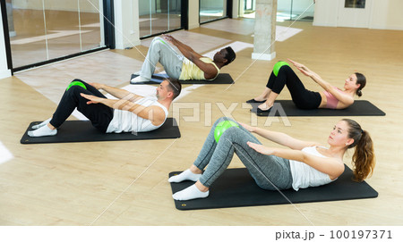 Sporty people training pilates at group class 100197371