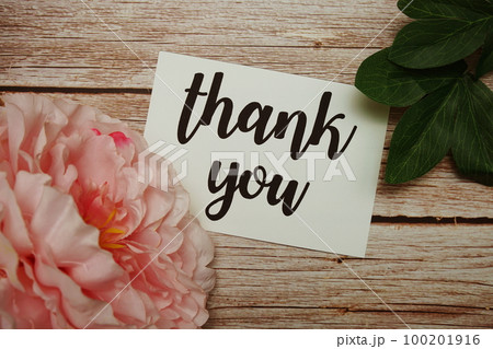 Thank You typography text with flower decorated on wooden background Thank You typography text with flower decorated on wooden background 100201916