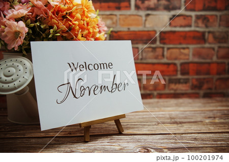 Welcome November text with flower bouquet decoration on wooden and old brick wall background Welcome November text with flower bouquet decoration on wooden and old brick wall background 100201974