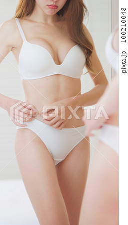 woman dissatisfied about body shape woman dissatisfied about body shape 100210048