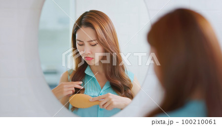 woman worry her hair 100210061