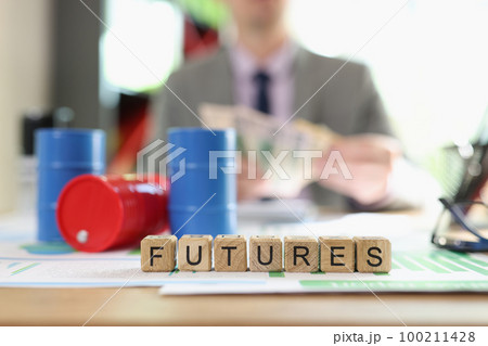 Letters futures collected from cubes and oil barrels on financial documents. 100211428