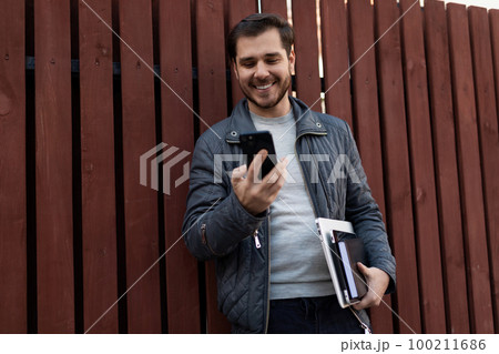 european freelance man chatting on the phone on the street european freelance man chatting on the phone on the street 100211686