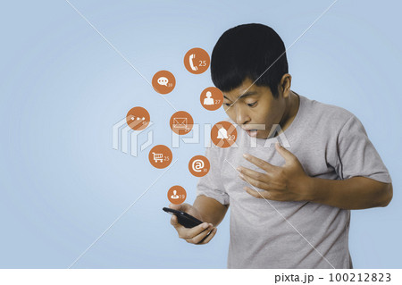Social media and digital online on mobile phone. man using smartphone shock and surprise with social media icon. 100212823