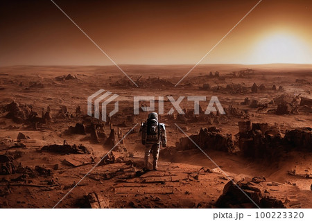 Astronaut stands on the edge of cliff. Mars exploration. Back view of astronaut in space suit walking on a mars. Ancient alien ruins In the distance Astronaut stands on the edge of cliff. Mars exploration. Back view of astronaut in space suit walking on a mars. Ancient alien ruins In the distance 100223320