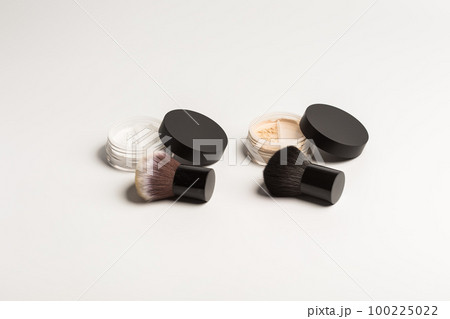 Mineral makeup powder twist seal sifter isolated on white background with brush. Many beige foundation powder. Skin tone face cosmetic product sample 100225022