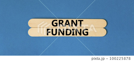 Grant funding symbol. Concept words Grant funding on wooden stick. Beautiful blue table blue background. Business and grant funding concept. Copy space. Grant funding symbol. Concept words Grant funding on wooden stick. Beautiful blue table blue background. Business and grant funding concept. Copy space. 100225878