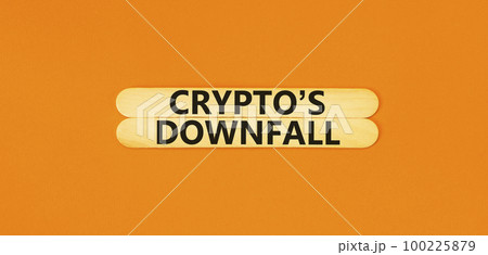 Crypto downfall symbol. Concept words Cryptos downfall on wooden stick. Beautiful orange table orange background. Business and crypto downfall concept. Copy space. 100225879