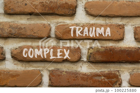 Complex trauma symbol. Concept words Complex trauma on red brown brick wall. Beautiful red brown brick wall background. Business psychology complex trauma concept. Copy space. 100225880
