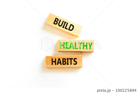 Motivation and Build healthy habits symbol. Concept words Build healthy habits on wooden block on a beautiful white table white background. Business build healthy habits concept. Copy space. 100225894