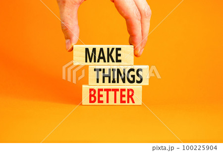 Make things better symbol. Concept words Make things better on wooden block on a beautiful orange table orange background. Businessman hand. Business and make things better concept. Copy space. Make things better symbol. Concept words Make things better on wooden block on a beautiful orange table orange background. Businessman hand. Business and make things better concept. Copy space. 100225904