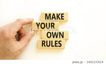 Make your own rules symbol. Concept words Make your own rules on wooden cubes. Beautiful white table white background. Businessman hand. Business motivational make your own rules concept. Copy space Make your own rules symbol. Concept words Make your own rules on wooden cubes. Beautiful white table white background. Businessman hand. Business motivational make your own rules concept. Copy space 100225924