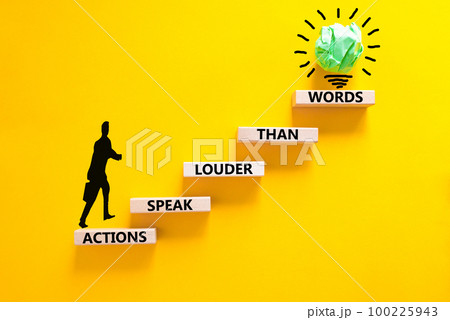 Actions speak louder words symbol. Concept words Actions speak louder than words on wooden blocks. Beautiful yellow table yellow background. Business new mindset for results concept. Copy space. 100225943