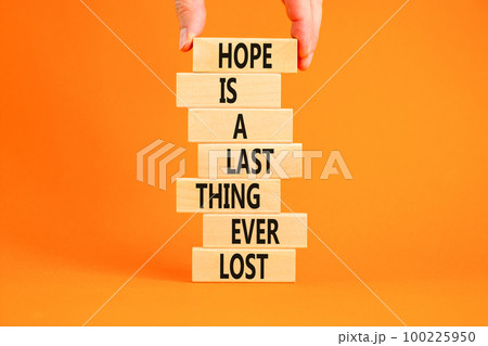 Do not lost hope symbol. Concept words Hope is a last thing ever lost on wooden blocks on a beautiful orange background. Businessman hand. Business motivational and do not lost hope concept. Do not lost hope symbol. Concept words Hope is a last thing ever lost on wooden blocks on a beautiful orange background. Businessman hand. Business motivational and do not lost hope concept. 100225950