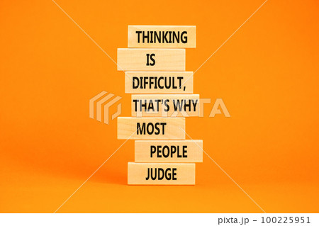 Thinking or judge symbol. Concept words Thinking is difficult that is why most people judge on blocks. Beautiful orange table orange background. Business thinking or judge concept. Copy space. Thinking or judge symbol. Concept words Thinking is difficult that is why most people judge on blocks. Beautiful orange table orange background. Business thinking or judge concept. Copy space. 100225951