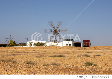 Stone desert and a windmill, Fuerteventura 100228551
