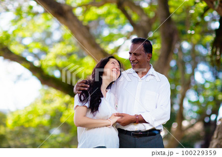 Interracial couple in summer park. Interracial couple in summer park. 100229359