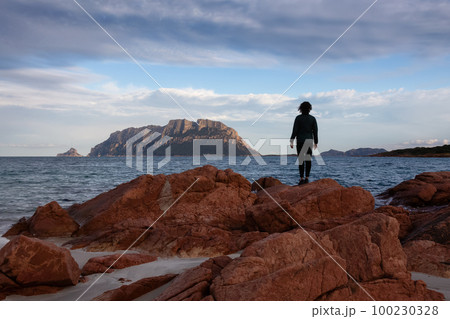 Rocky and Sandy Beach in Porto Istana, Sardinia, Italy. Tavolara Island in Background. 100230328