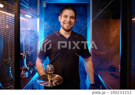Portrait of smiling hookah man holding traditional eastern accessory for smoking 100233252