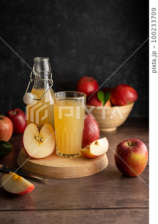 Apple juice drink with fresh red apples, wooden background. dark bakground 100233709