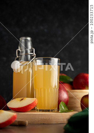 Apple juice drink with fresh red apples, wooden background. dark bakground 100233715