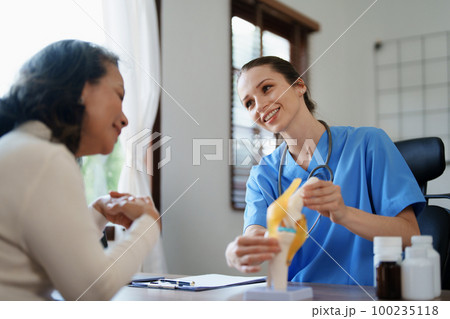Portrait of a female doctor talking to an elderly patient about osteoarthritis Portrait of a female doctor talking to an elderly patient about osteoarthritis 100235118