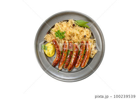 Fried Nuremberg sausages with sauerkraut served on a pewter plate isolated on white background 100239539