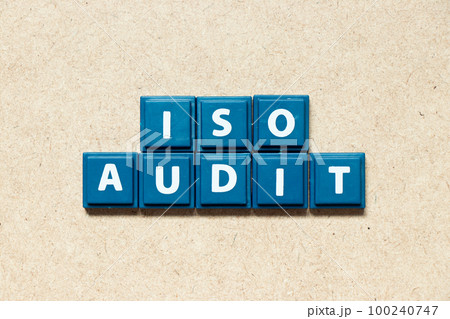 Tile alphabet letter in word ISO audit on wood background 100240747