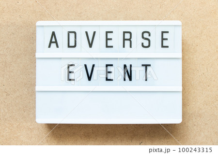 Lightbox with word adverse event on wood background 100243315