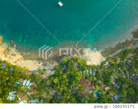 aerial top view Ao Sean small white sand beach lined with rocks. turquoise sea at Ao Sane beach Phuket. colorful blue sea background. beautiful nature in the hidden beach. aerial top view Ao Sean small white sand beach lined with rocks. turquoise sea at Ao Sane beach Phuket. colorful blue sea background. beautiful nature in the hidden beach. 100245575