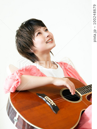ギターを弾く若い女性 100248679