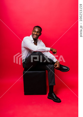 Young african man standing shirtless with a happy and cool smile on face. lucky person. 100253159