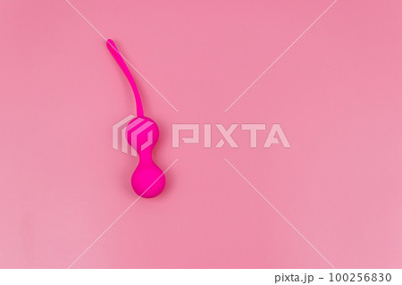Ben Wa balls or Geisha balls on pink background. Pink double vaginal balls Ben Wa balls or Geisha balls on pink background. Pink double vaginal balls 100256830