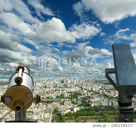 Telescope viewer and city skyline at daytime (against the background of very beautiful clouds). Paris, France. 100258557