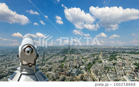 Telescope viewer and city skyline at daytime (against the background of very beautiful clouds). Paris, France.  100258668