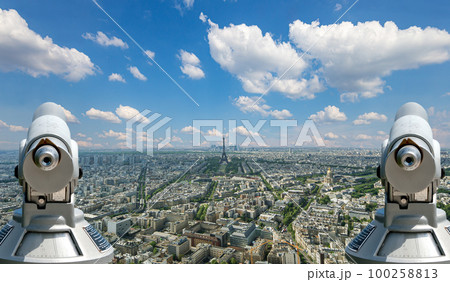 Telescope viewer and city skyline at daytime (against the background of very beautiful clouds). Paris, France.  100258813