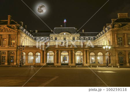 The historic center of Paris at night (with the moon), France. Building of the Council of State of France (written in French) 100259118