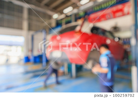 Red car lift at maintenance station in automotive service center blur abstract background 100259702