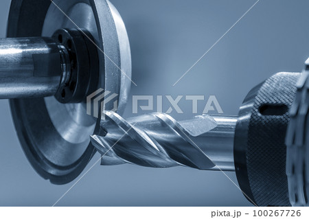 Close up scene the flat end mill tool regrinding process on regrinding machine. Close up scene the flat end mill tool regrinding process on regrinding machine. 100267726