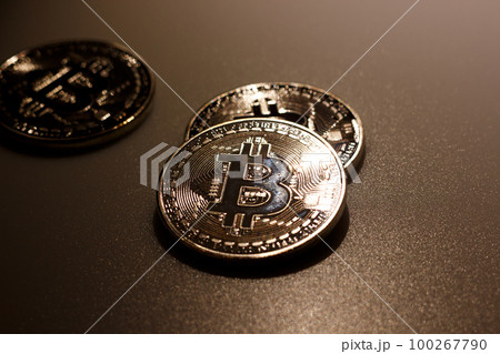 Close up bitcoins on table and reflection of light Close up bitcoins on table and reflection of light 100267790