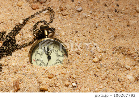 Retro style clock in the sand 100267792