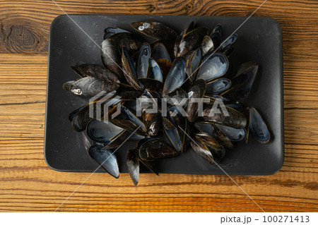 Empty Mussels Shell, Black Clams Shells, Eaten Mollusc, Shellfish, Mussel on Wood Background Top View 100271413