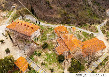 Top view of brownish tiled roofs of medieval Shio-Mgvime monastery, Mtskheta, Georgia 100271712