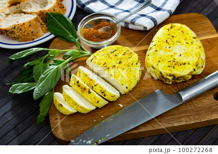 Sliced fried cottage cheese with cumin and turmeric on wooden board Sliced fried cottage cheese with cumin and turmeric on wooden board 100272268